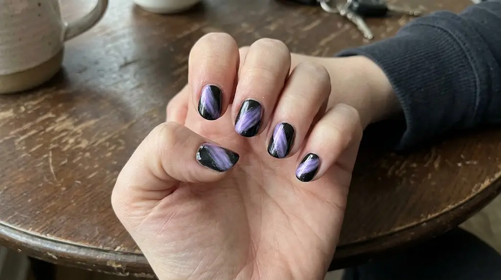 Aurora Streaks Across Black Nails