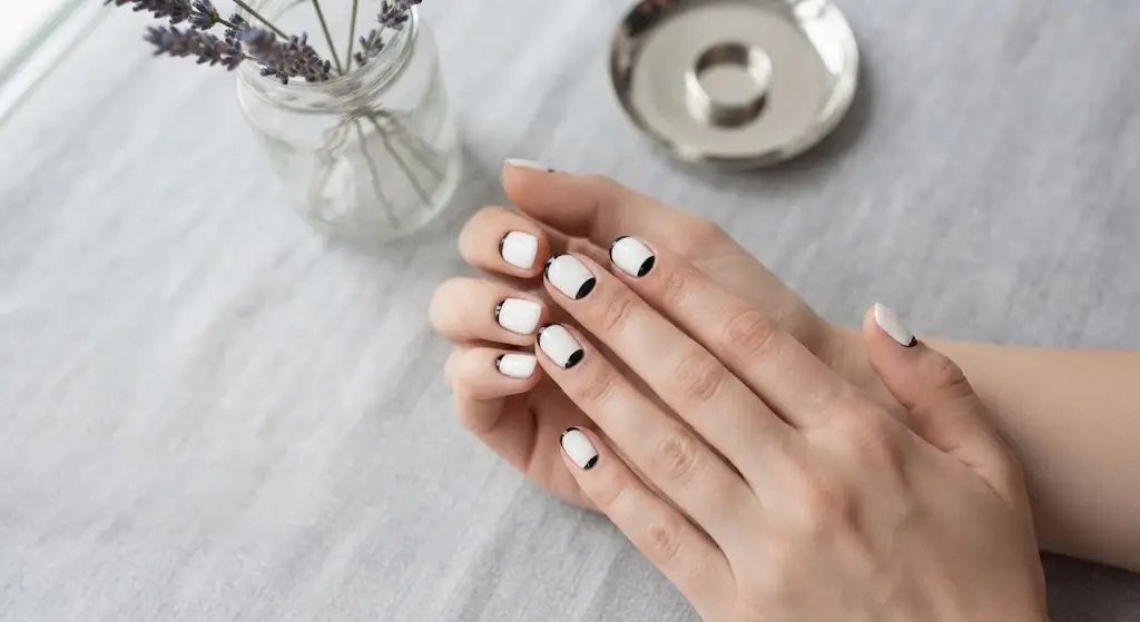 Black arch at the base of white nails