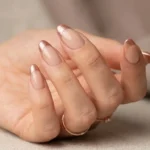 Nude nails with frosted rose gold shimmer french tips